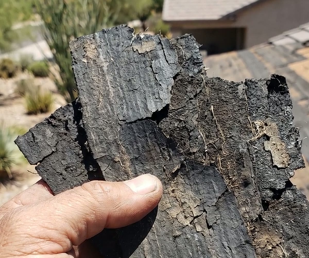 Brittle failed roof underlayment removed from an Arizona tile roof